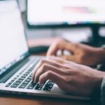 Someone typing on a keyboard